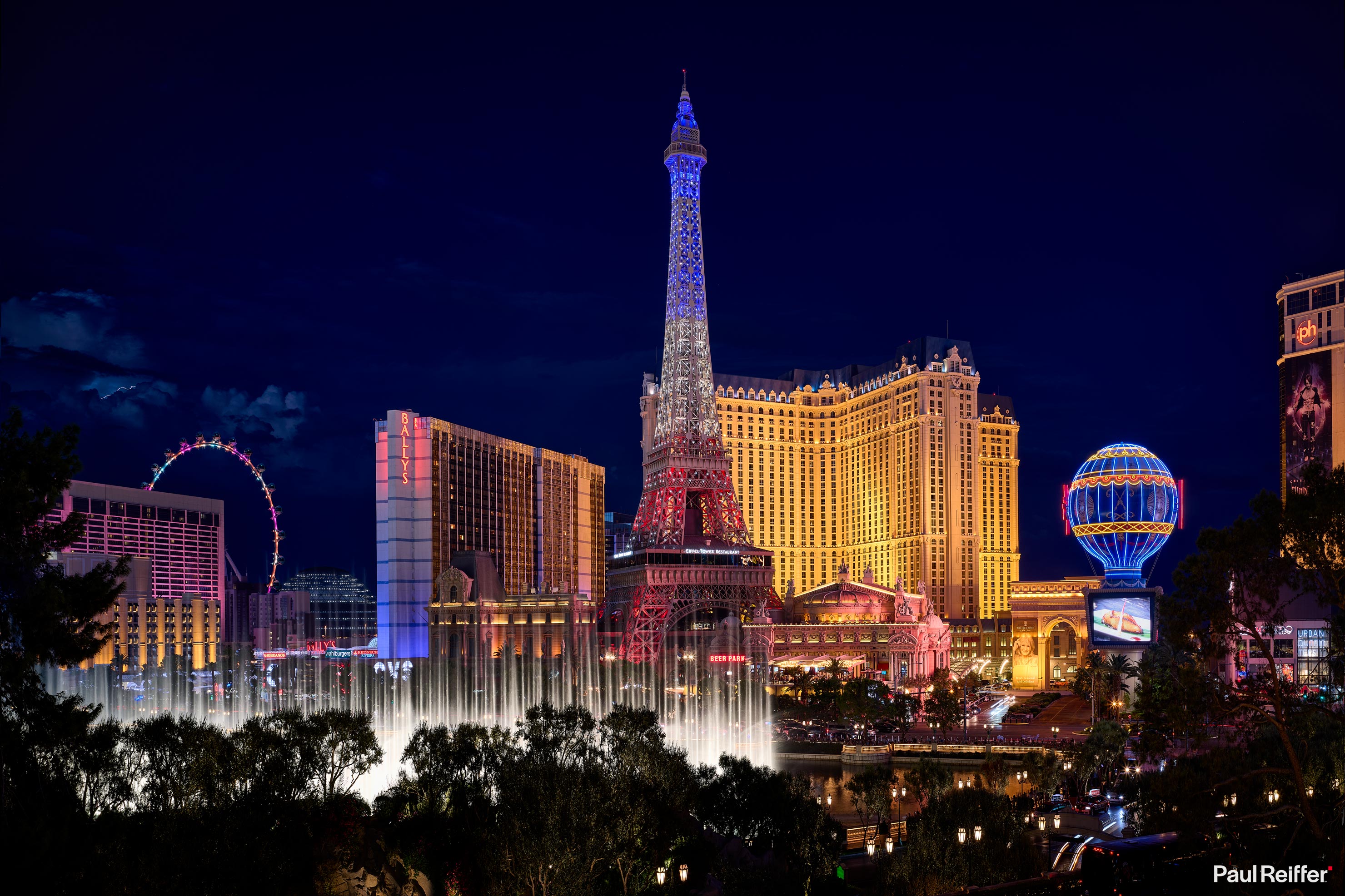 The Las Vegas Strip at night — the Bellagio fountains and Paris Las Vegas Eiffel Tower
